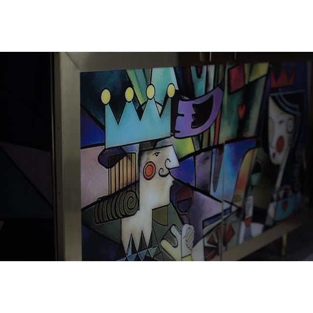 This two-door cabinet is a masterpiece of design and art, featuring a framed depiction of Pablo Picasso's painting "Thou...