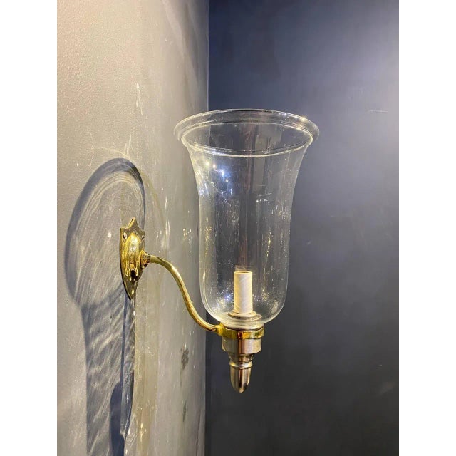 A circa 1900 traditional gild bronze and silver plate finish sconces with hurricane glass inset. Williamsburg style....