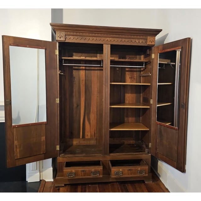 Offering a gorgeous large signed 19th century walnut armoire wardrobe with drawers and shelves. This beautiful piece of...
