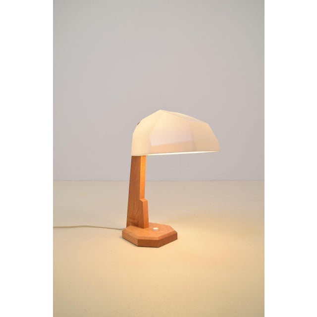 Rare table lamp designed by Rudolf Dörfler in the 1960s. The beautifully shaped ash wood base flows into a stunning...