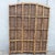 A beautifully textured vintage three-panel folding room divider crafted with densely woven natural wicker in warm honey,...