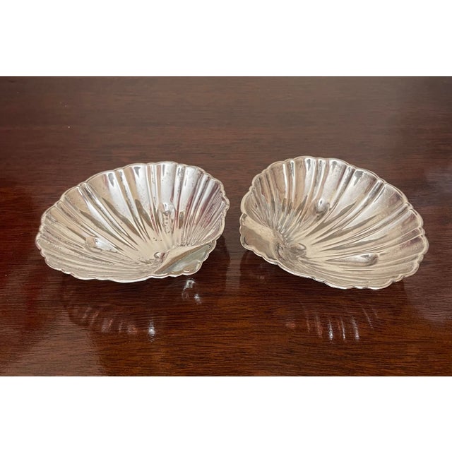 This beautiful pair of small bowls are sterling silver and marked on the back. They are in the shape of of scalloped...