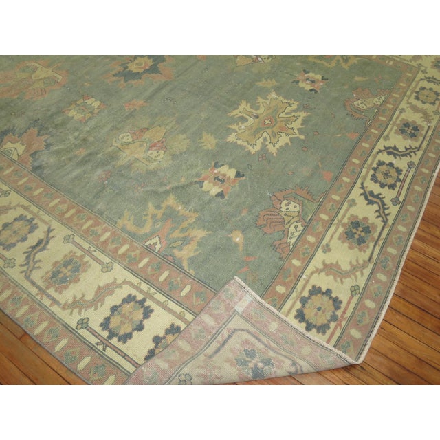 3rd quarter of the 20th Century worn Oushak Rug in feminine colors