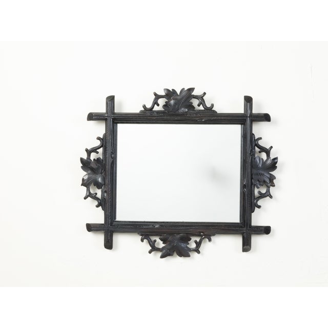 A French black forest mirror from the early 20th century, with hand-carved oak leaves. We currently have two mirrors...