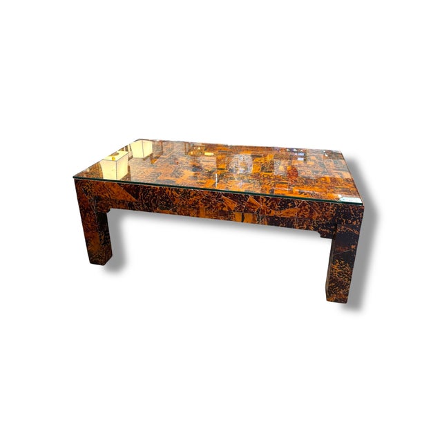 A bold statement piece with serious vintage character. This rectangular coffee table features a rich tortoise shell-style...