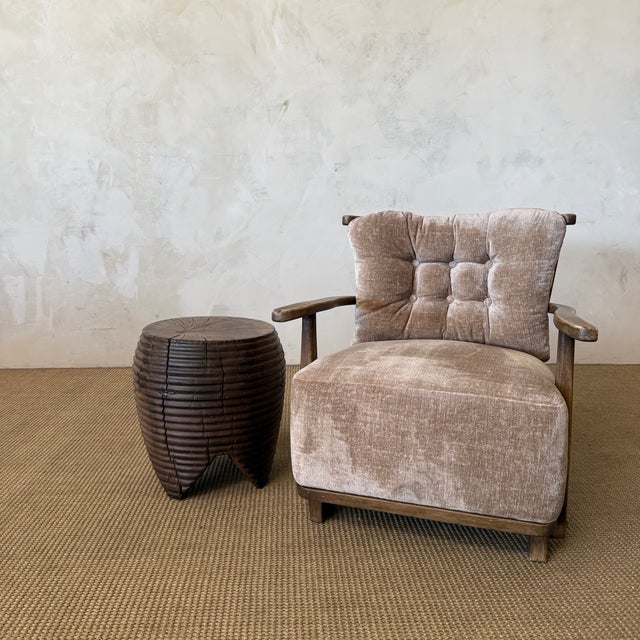 Expertly carved from solid walnut, this sculptural side table highlights the rich grain and natural character of the wood....
