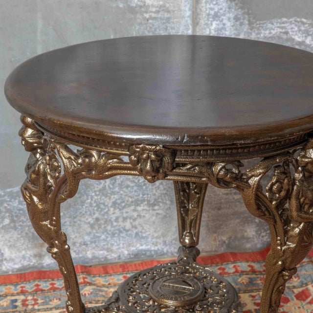 A fully restored victorian britannia pub/conservatory table. Shot blasted and powder coated to a dark gold/bronze colour...