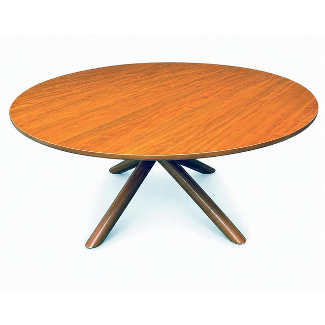 Beautiful round dining table featuring angular, intersecting legs often described as a “starburst” or “atomic” base. The...