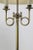 Brass floor lamp having two bulbs supported by coiled brass arms, with original oval shade, shade shows some...