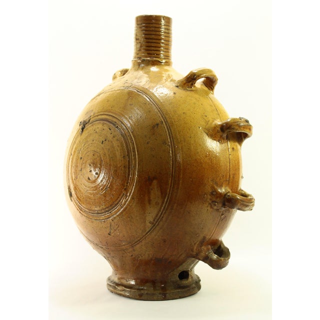 A majestic and early vessel An extra large salt glazed canteen or flask used by pilgrims following the route towards...