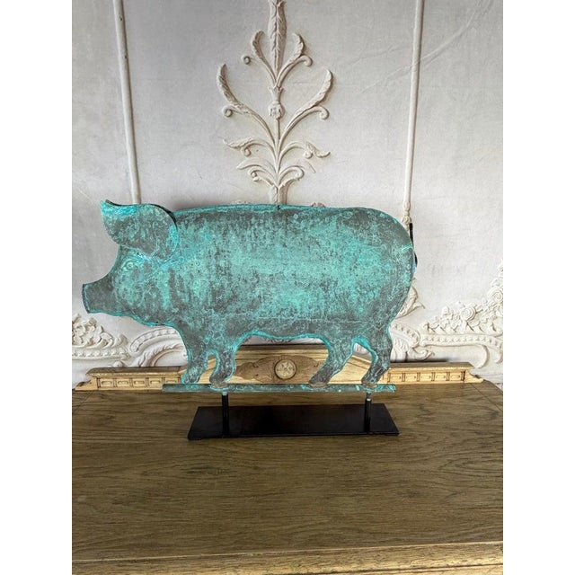 A striking vintage copper pig sculpture featuring a beautifully aged verdigris patina and charming folk art character....