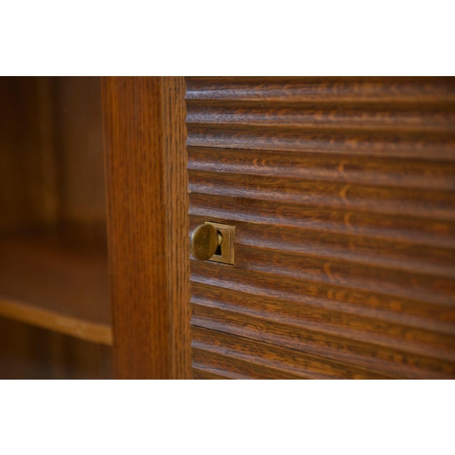 A superb oak display cabinet in a Brutalist/late Art Deco style, typical of French production from the 1930s and 40s. The...