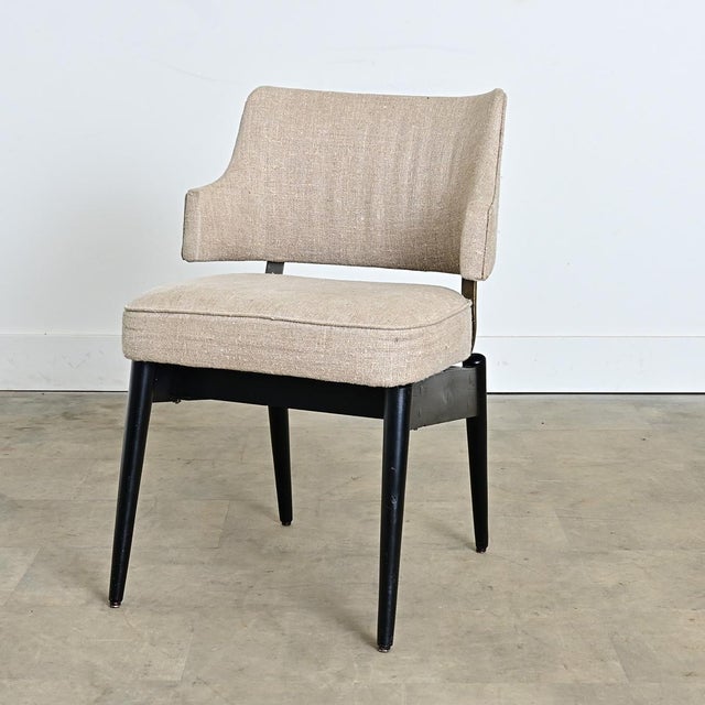English vintage mid-century modern armchair in the manner of Kofod-Larsen with a detached seat back on springy metal bars...