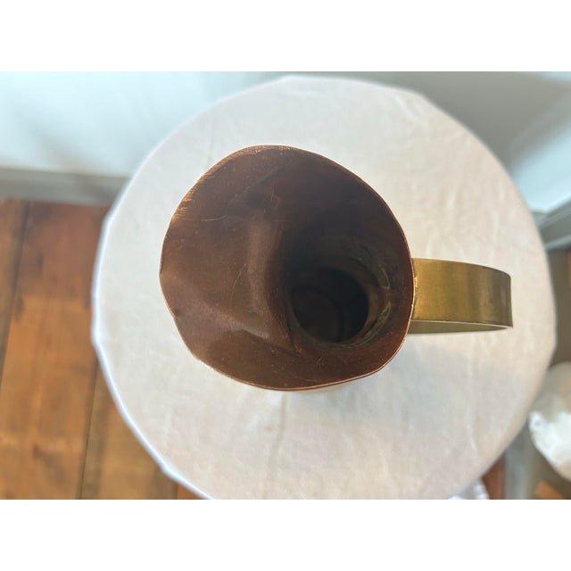 A unique pitcher that combines the beauty of cooper and brass with a slender neckline that opens to a wider base. The...