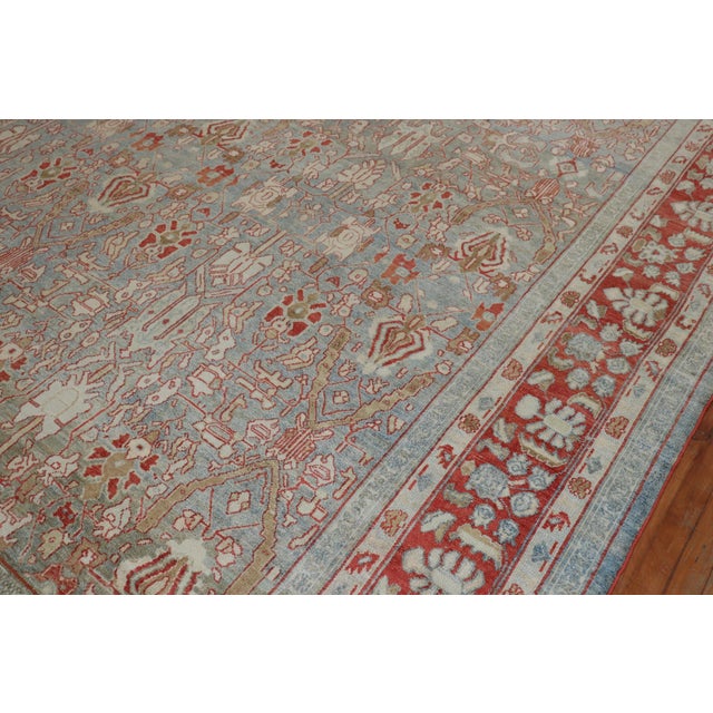 An early 20th century Persian Bibikabad rug with a striking gray blue field and soft red border. Accents in brown, silver...
