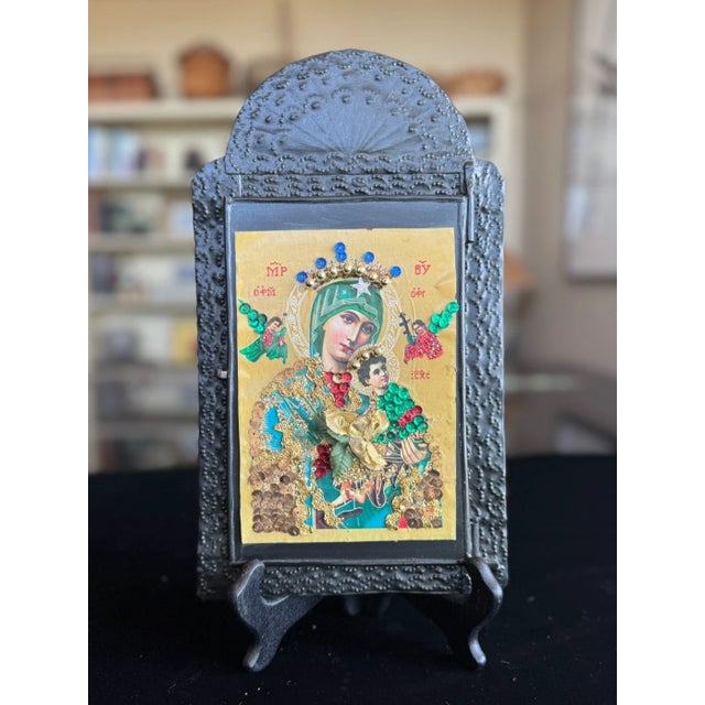 This vintage Mexican nicho shrine is a mixed-media devotional work assembled from metal, paper, and applied decorative...