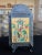 This vintage Mexican nicho shrine is a mixed-media devotional work assembled from metal, paper, and applied decorative...