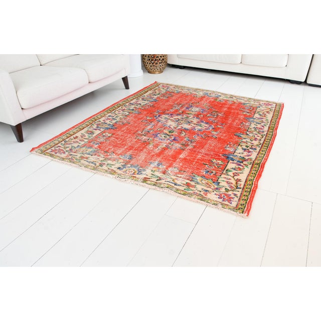 This is a vintage Turkish Oushak rug from the Mid 20th Century. The piece was hand-knotted.