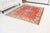This is a vintage Turkish Oushak rug from the Mid 20th Century. The piece was hand-knotted.