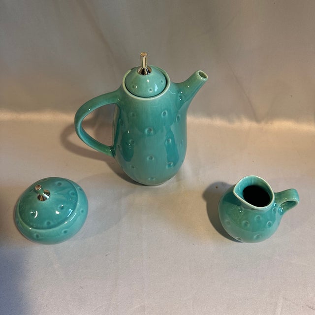 A rare 1940's era Royael Haeger jade green ceramic coffee set with an indented surface and silvertone finials. Coffe pot...