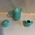A rare 1940's era Royael Haeger jade green ceramic coffee set with an indented surface and silvertone finials. Coffe pot...