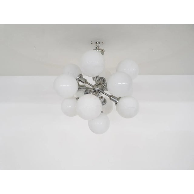 About this item Silver metal pendant light with 13 white glass globes. The globes have a diameter of each 12 cm. The light...