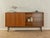 A wonderful sideboard from the 1960s. Its body is made of walnut veneer with two cabinet doors, two sliding glass doors,...