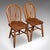This is a set of four vintage side chairs. An English, ash and elm hoop back reception hall seat with military broad...
