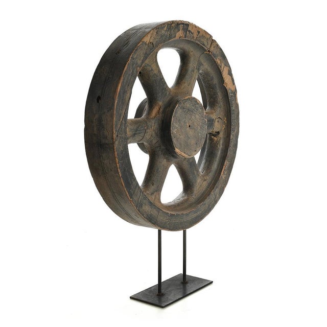 wooden wheel disposed on a foot of iron. This piece is designed in the style of the selected designer and/or manufacturer