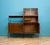 A mid century walnut sideboard shelving unit with a desk designed by Peter Hayward for Vanson, circa 1950 Featuring two...