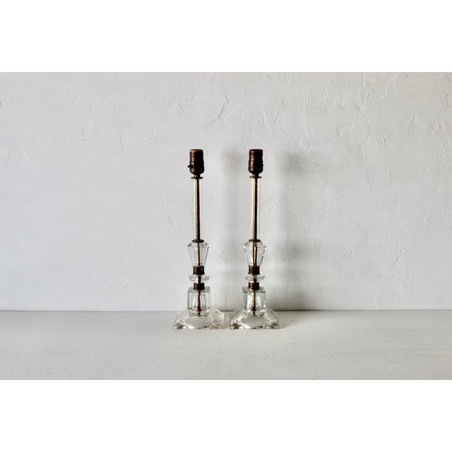 Pair of vintage mid-century clear stacked glass boudoir or candlestick table lamps with brass accents and square stepped...