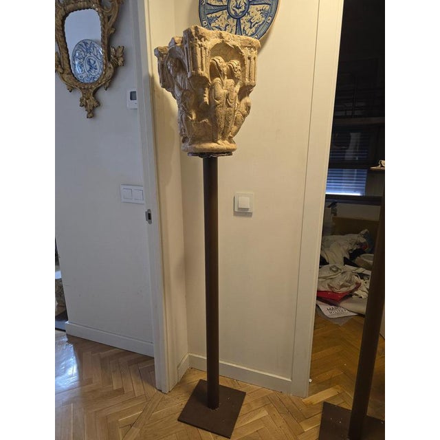 Decorative Romanesque-style stone capital, carved in the 20th century and mounted on a pedestal for display. Inspired by...