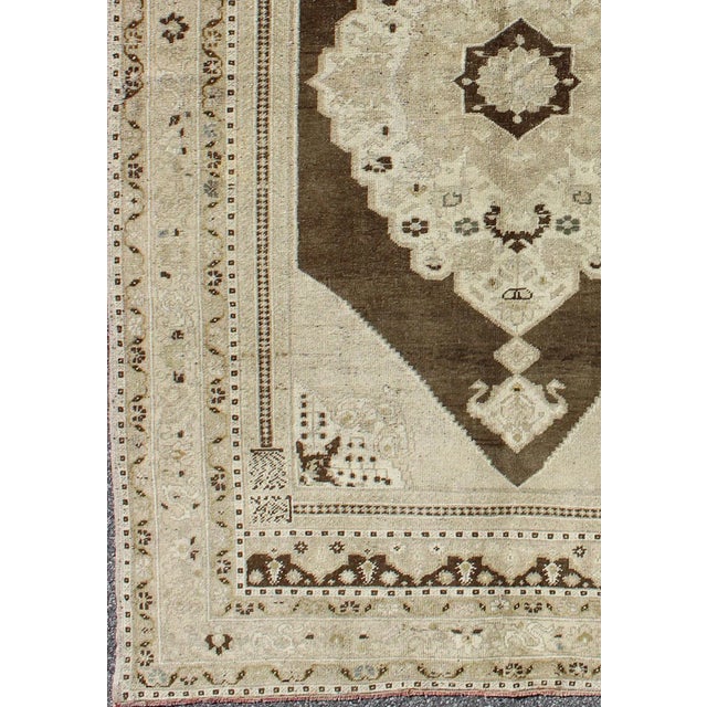 Measures: 4'9 x 7'8 Vintage Turkish Oushak Rug in Taupe and Mocha Brown with Cream Medallion 4′9″ × 7′8″ Keivan Woven Arts...