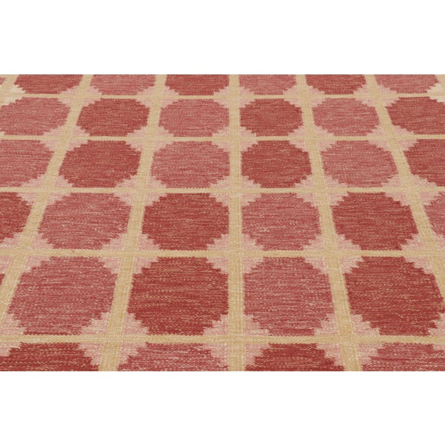 This custom oversized 8x10 Scandinavian rug showcases a refined geometric design in bold rust-red and soft beige....