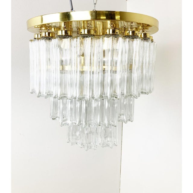 Striking flush mount chandelier by Glashutte Limburg with hand made glass pendants and a brass frame. The chandelier emits...