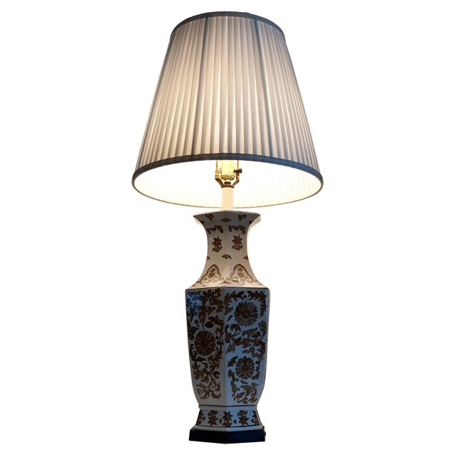 The hexagon shape and the elegant design of floral and botannical elements make this lamp a standout on a white...