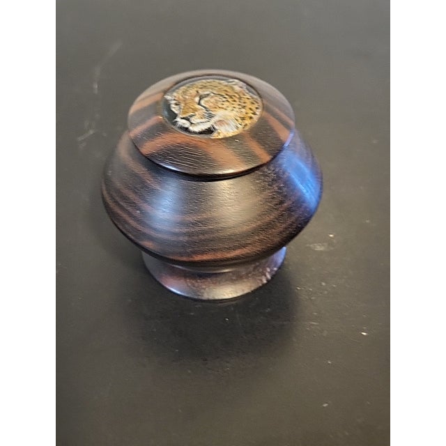 A round wood decorative storage jar to hold tobaccco or small items. Beautiful craftmanship and veining. Would look great...