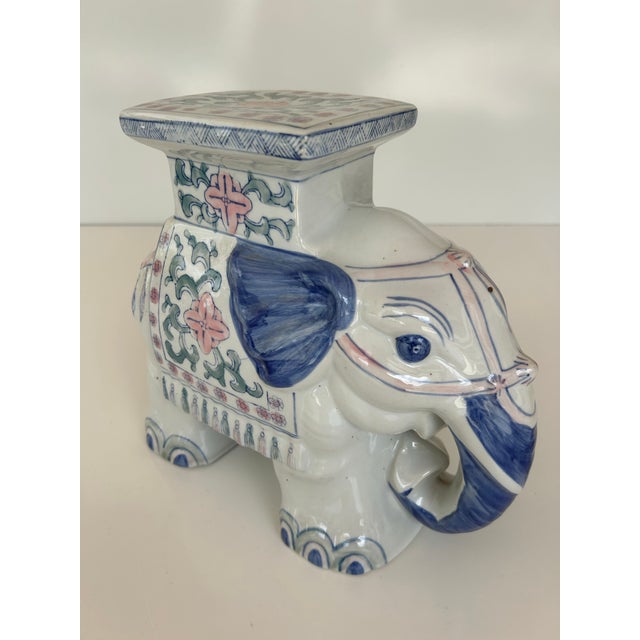 Vintage Chinoiserie elephant plant stand, adorned with delicate floral patterns in soft blues and pinks, offers both...