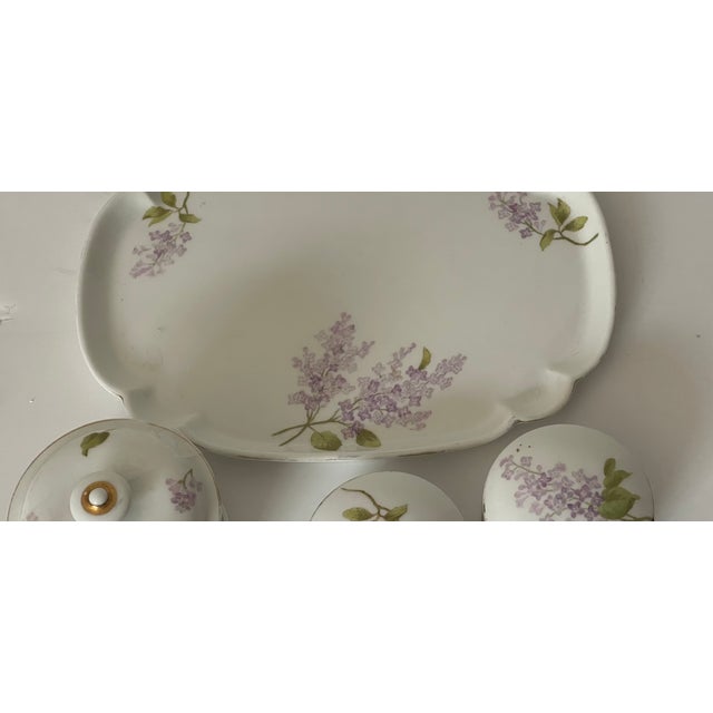 Antque French Limoges porcelain ladies vanity set with lilacs and tray with 3 boxes with lids. 10” tray, boxes 4” and 3”.