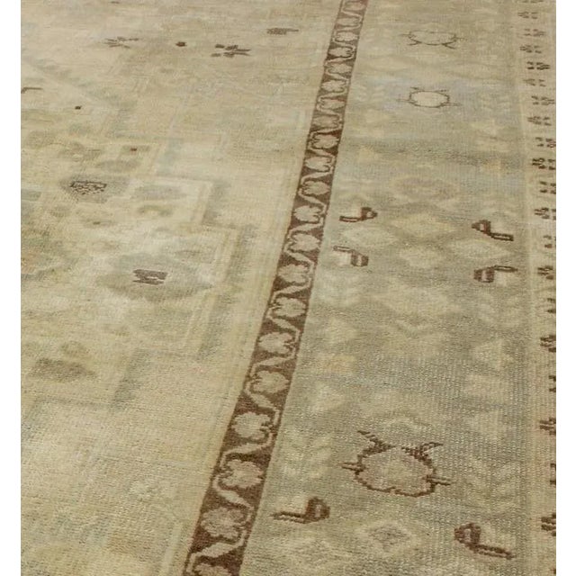 This stunning Turkish Oushak displays a gray/blue border and taupe background with brown highlights. The bold geometric...