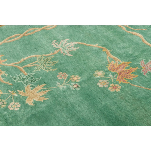 Hand-knotted in wool, this 5x5 contemporary Chinese Deco square rug features a luminous jade-green field framed by...