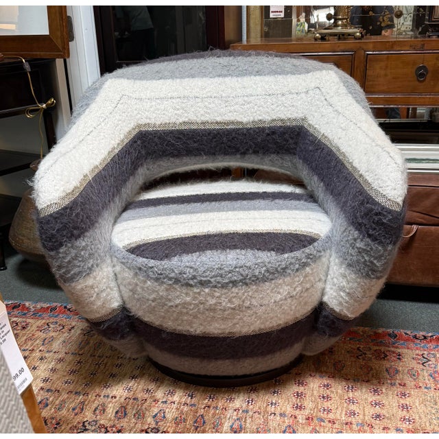 Design Plus Gallery presents a Swivel Chair in Gray Sheepskin Striping. This is the chair that will envelop you and is...