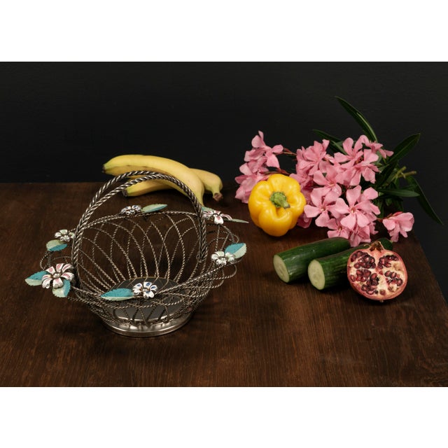 This silver plated Mid Century vintage fruit basket from the 1950s features a delicate yet robust construction made of...