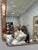 Charming and highly decorative Art Deco wall mirror featuring a beveled central mirror plate with an etched figural design...