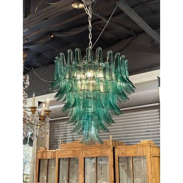 Stunning saddle shaped green Murano glass waterfall chandelier. Makes a beautiful statement. So pretty!!