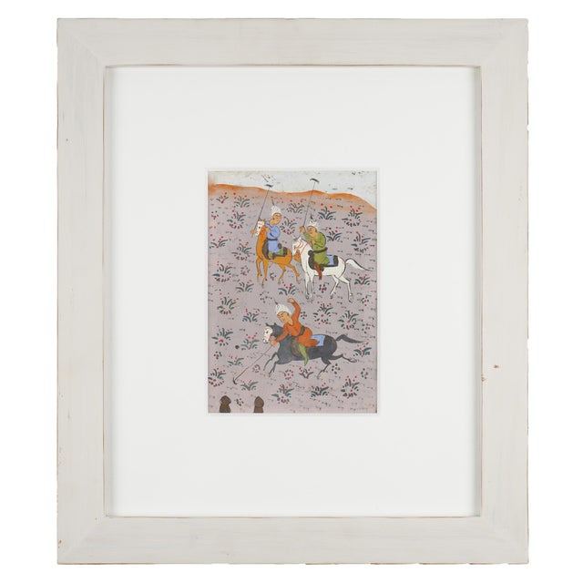 A well-matched pair of antique Persian miniature paintings, each depicting a trio of polo players — chovgan — mid-swing as...