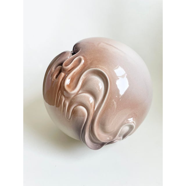 Artist signed abstract ceramic vase with beige tones and flowing details. Measures 11" tall and 10.5" in diameter.