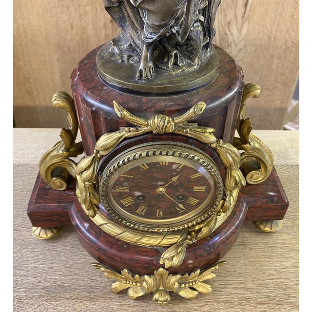 A truly superb quality French Rouge Marble and Ormolu mounted clock with a Classical Bronze Maiden on top. We have not...