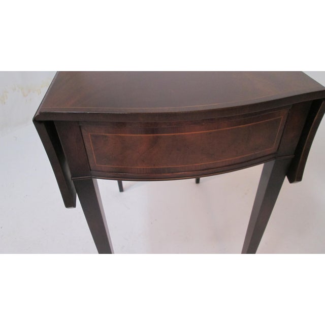 This is a beautiful Pembroke table made by Baker furniture. The table is made of mahogany with string inlays. When both...