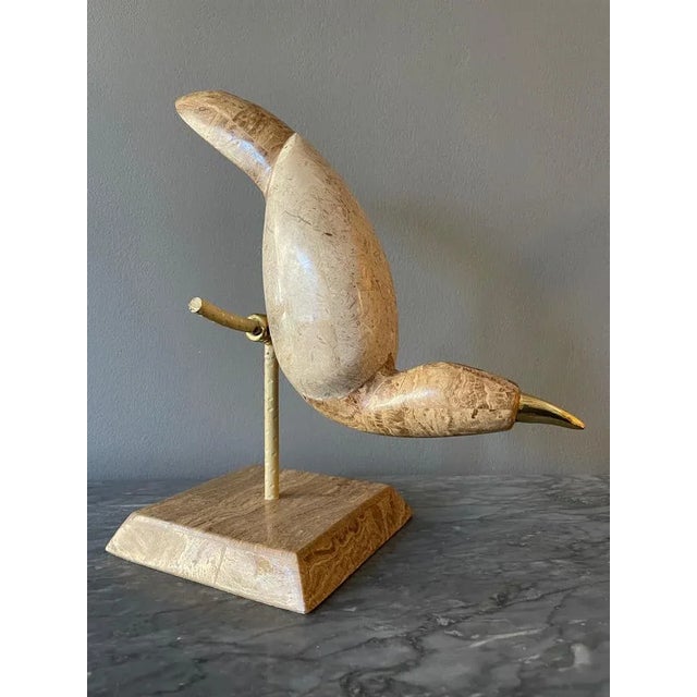 A pair of stylised tessellated marble and brass perched birds by Maitland Smith USA circa 1980. This piece is attributed...